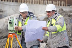 land surveyor examining paperwork for construction project