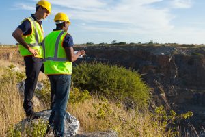 two ATLA surveyors working on surveying land