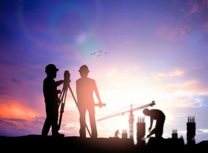 a team of people wearing hard hats performing a land survey