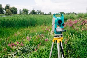 a green field with a theodolite