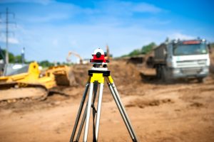 land surveyor equipment standing on a undeveloped lot