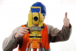 land surveyor behind his equipment