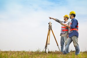 Land surveyor surveying the land