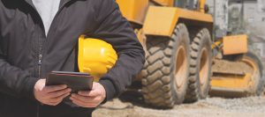 Construction worker using tablet on the site.