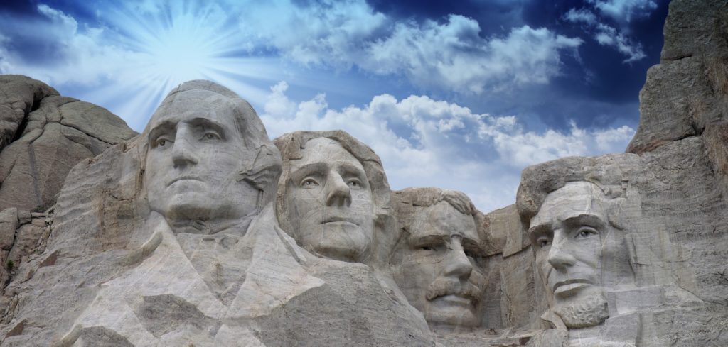 mount rushmore with a beautiful blue sky as a backdrop