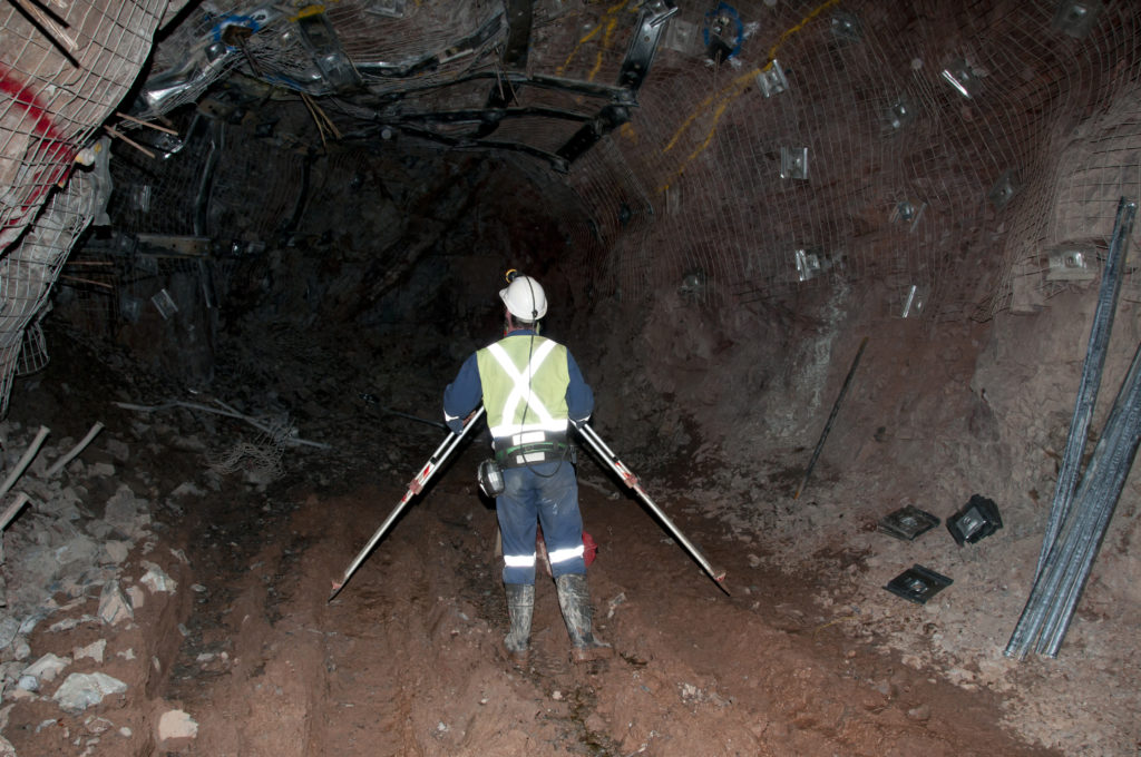 an underground land surveyor readying his theodolite