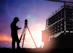 silhouette survey engineer working  in a building site over Blur